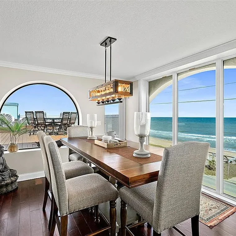 Dining room with arched window and Atlantic Ocean views in the oceanfront penthouse