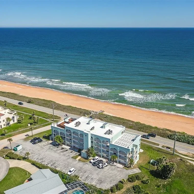 Aerial view of the Ocean Aire condominium building and its oceanfront position on the Ormond-by-the-Sea barrier island